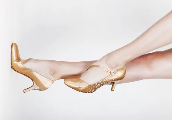 Dancer legs wearing ballet shoes on white background horizontal Rechtenvrije Stockfoto's