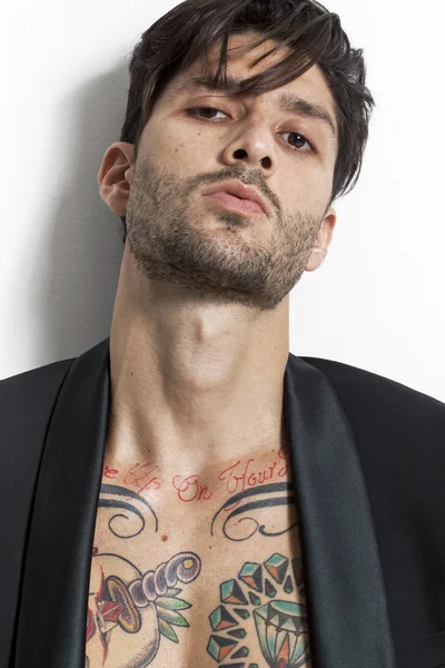 Tattooed man closeup portrait wearing black jacket — Stock Photo, Image