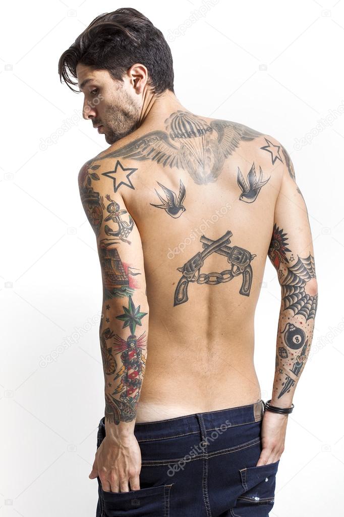 Handsome and sexy tattooed man back portrait