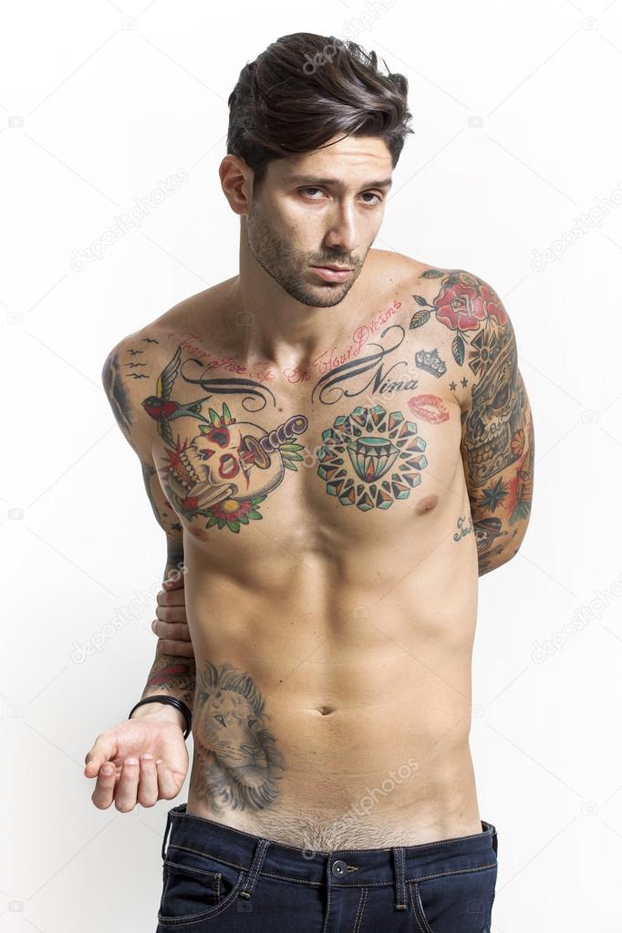 Handsome and sexy tattooed man portrait looking at camera