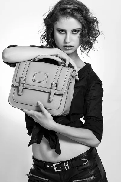 Beautiful girl holding a bag and looking black and white — Stock Photo, Image