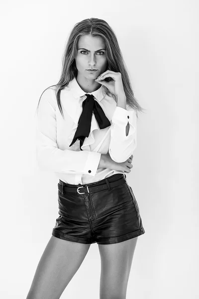 Beautiful woman wearing blouse and leather shorts black and whit — Stock Photo, Image