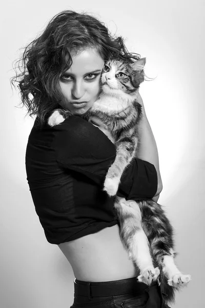 Cute girl portrait hugging a beautiful cat black and white — Stock Photo, Image