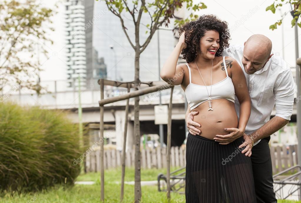 Cheerful and beautiful couple expecting baby