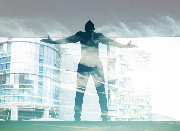 Double exposure of dancer silhouette in the city and cloudscape