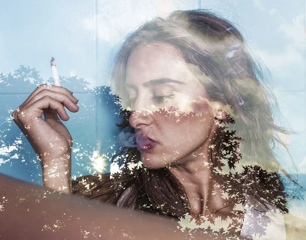 Double exposure of woman smoking and tree silhouette — Stock Photo, Image