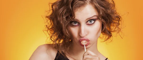 Beautiful girl closeup portrait sucking a lollipop letterbox — Stock Photo, Image