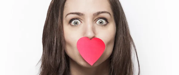 Girl with heart-shaped post-it on her mouth letterbox — Stock Photo, Image