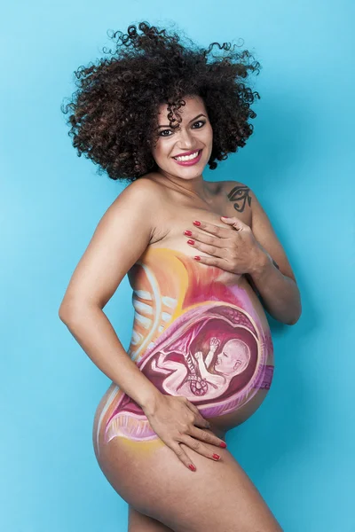 Beautiful woman with baby painted on pregnant belly smiling — Stock Photo, Image