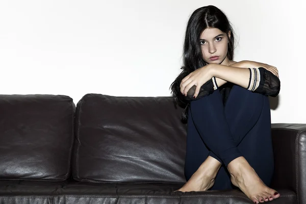 Beautiful girl portrait sitting on the sofa — Stock Photo, Image