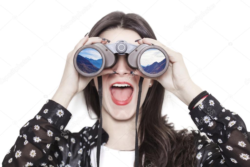 Girl portrait looking at mountains through binoculars