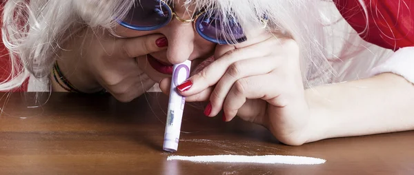 Rich female Santa Claus sniffing sugar with bill letterbox — Stock Photo, Image