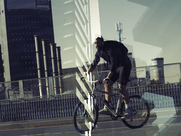 Double exposure of biker portrait and cityscape — Stock Photo, Image