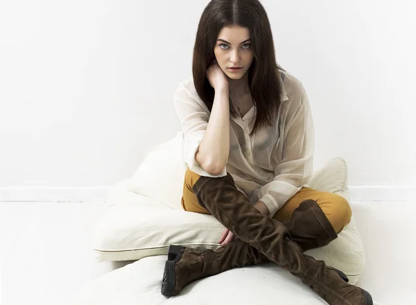 Pretty girl portrait sitting on cushions — Stock Photo, Image