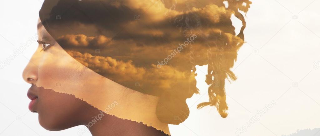 Double exposure of profile woman portrait and sunset clouds lett