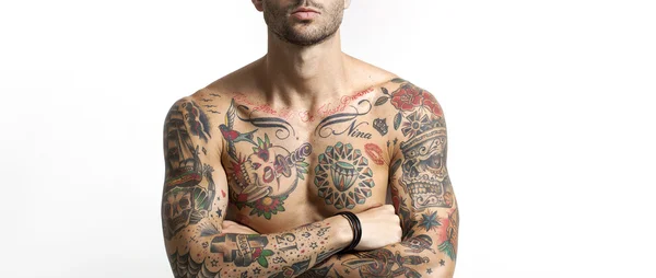 Handsome and sexy tattooed man portrait with crossed arms letter — Stock Photo, Image