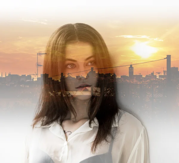 Double exposure of girl with gorgeous eyes and city sunset — Stock Photo, Image