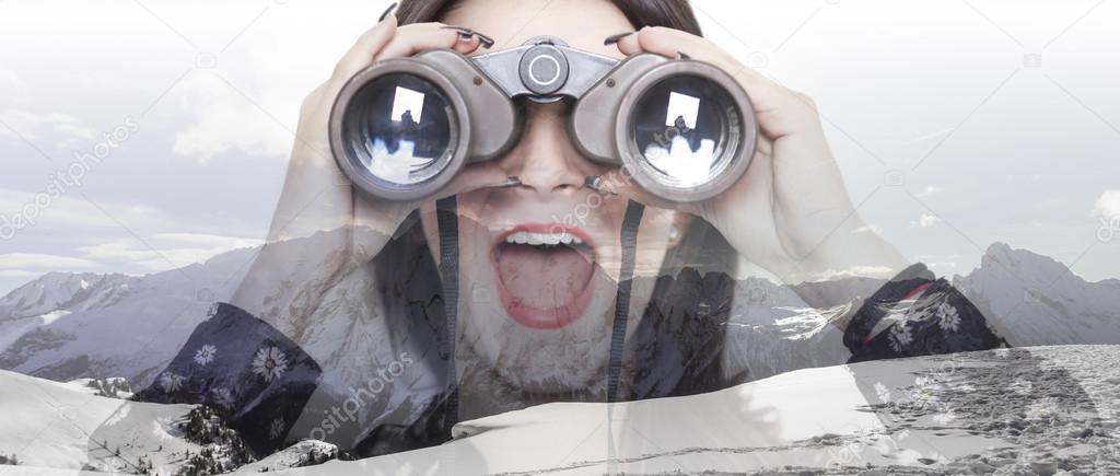Double exposure of girl with binoculars and mountainscape letter