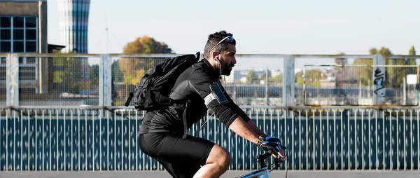 Sportsman profile portrait riding bicycle in the city — Stock Photo, Image