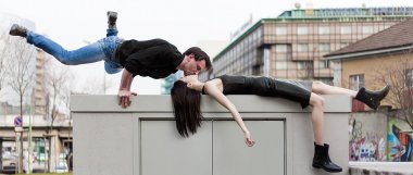 Funny and athletic man kissing girlfriend in the city letterbox clipart