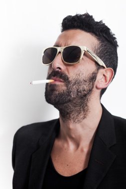 Güneş gözlüğü ve Sigara İçilmeyen giymiş yakışıklı adam portresi
