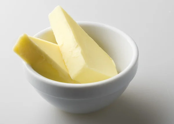 Carved butter served in white dish — Stock Photo, Image