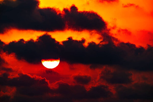 Colorful sun in the clouds background