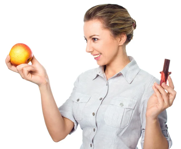 Conceito de dieta: Mulher escolhendo entre frutas e chocolate — Fotografia de Stock