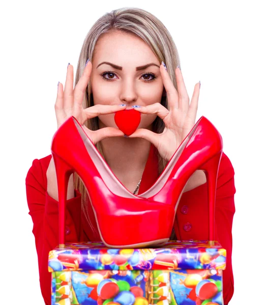 Young beautiful woman happy to receive red high heels shoes as a present — Stock Photo, Image