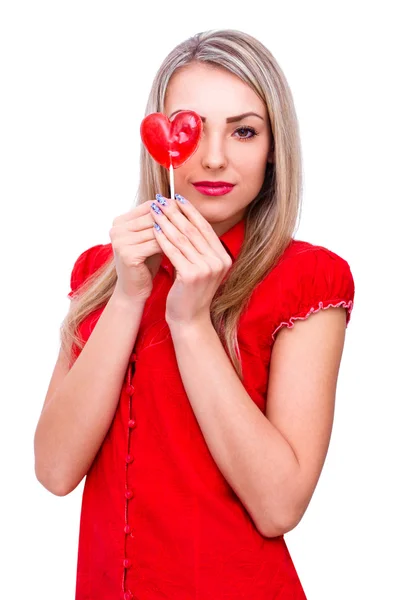 Beautiful young woman holding heart shape lollipop on white — Stock Photo, Image