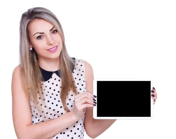 Joven mujer alegre está mostrando mesa en blanco —  Fotos de Stock