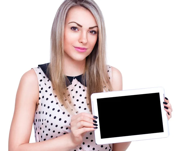 Joven mujer alegre está mostrando mesa en blanco —  Fotos de Stock