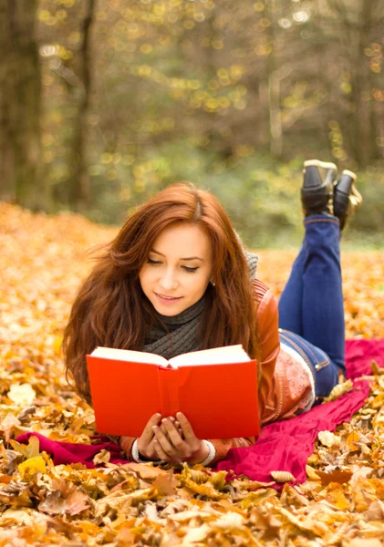 Happy young woman with book Stock Photo