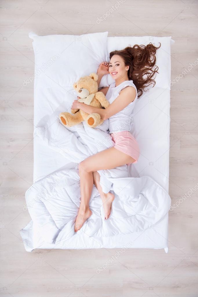 Charming woman lying in bed