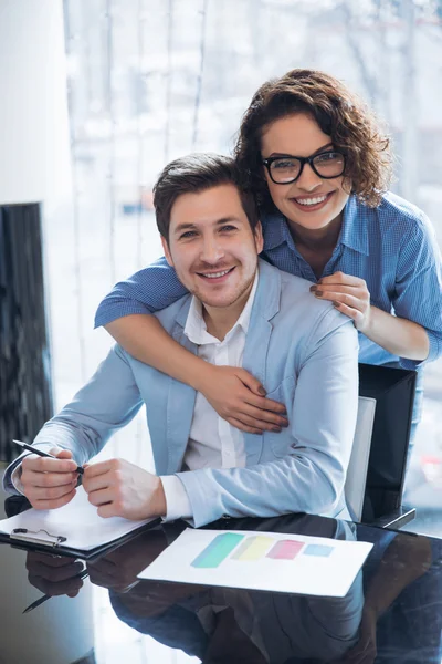 Pleasant colleagues embracing — Stock Photo, Image