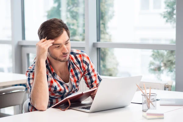 Knappe man zit aan de tafel — Stockfoto