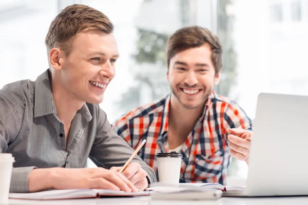 Pleasant men sitting at the table — Stock Photo, Image