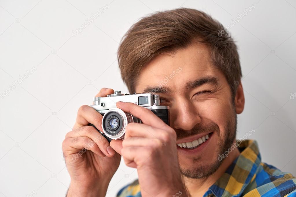 man taking picture with his camera
