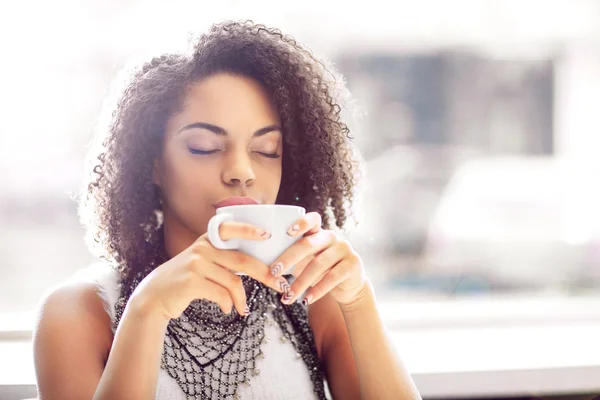 Pleasant girl drinking coffee — Stock Photo, Image