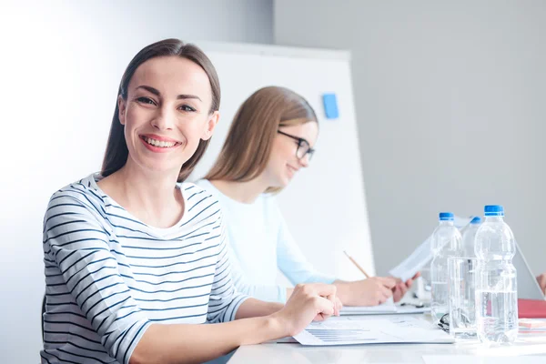 Pleasant female colleagues sitting at the table — Stock Photo, Image