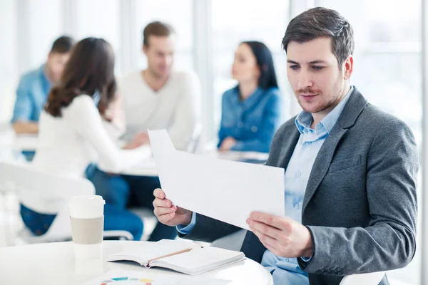 Pleasant man sitting at the table — Stock Photo, Image