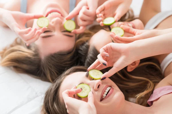 Positive girls lying on the bed — Stock Photo, Image