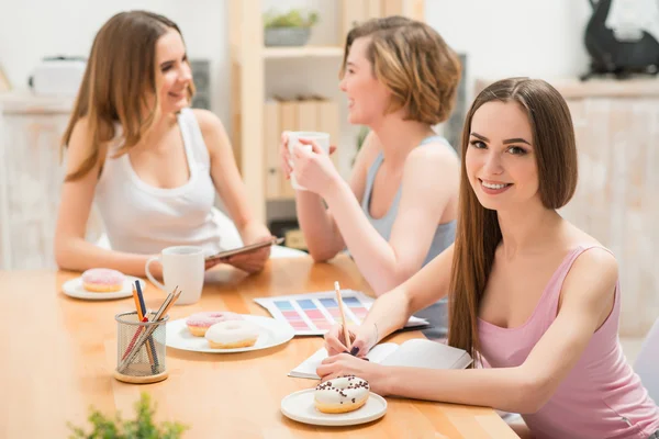 Delighted girls sitting at the table — Stok fotoğraf