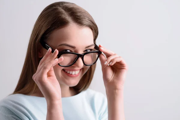Chica positiva sosteniendo sus gafas — Foto de Stock