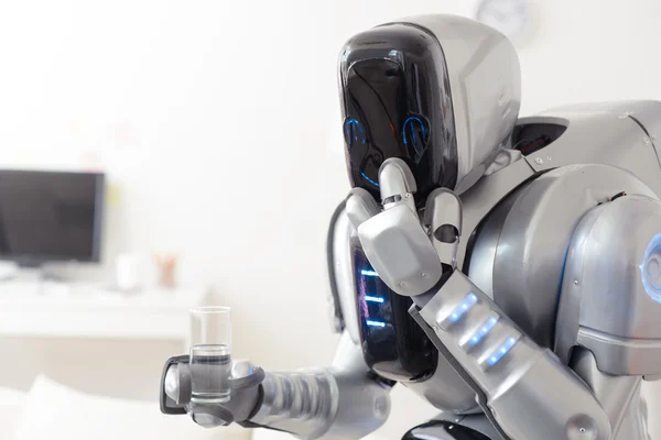 Robot holding glass of water — Stock Photo, Image