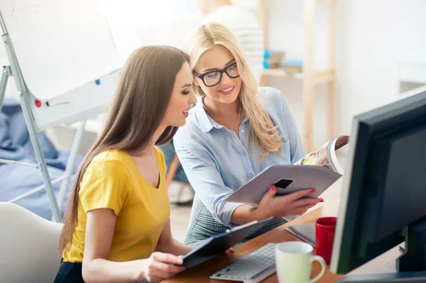 Positive colleagues sitting at the table — Stock Photo, Image