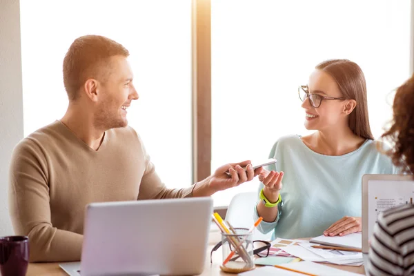 Colegas positivos sentados à mesa — Fotografia de Stock