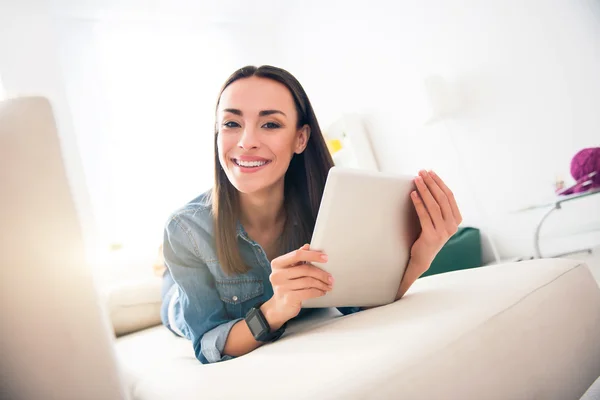 Pleasant beautiful woman resting on the couch — Stok fotoğraf