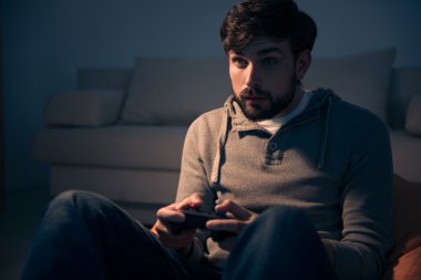 Bir video oyunu denetleyicisi elinde tutan gammer