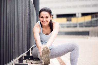 Woman stretching and looking at camera